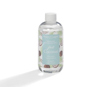 May include: A clear glass bottle of Hassett Green London Just Coconut fragranced reed diffuser refill. The label features coconut and palm leaf illustrations. The bottle contains 250ml of a rich creamy coconut fragrance.
