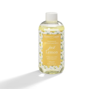 May include: A clear glass bottle of Hassett Green "just Lemon" fragranced reed diffuser refill. The label is yellow with lemon illustrations and text. The bottle contains 250ml of lemon fragrance.