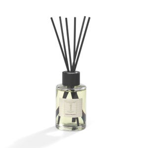 May include: A clear glass diffuser bottle with black reeds. The bottle has a black cap and a label with text. The liquid inside is light yellow. The product is designed for home fragrance.
