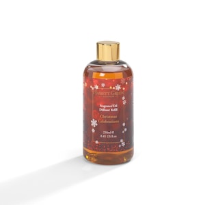 May include: A Hassett Green London fragrance oil diffuser refill bottle with a gold cap. The label reads "Christmas Celebrations" and features snowflake and star accents. The amber-colored liquid is visible inside. The bottle contains 250ml.
