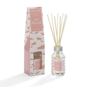 May include: A glass reed diffuser with wooden reeds and a silver lid, alongside a patterned box. The box and bottle are labelled "just Rhubarb". The box features a pink and white rhubarb design.