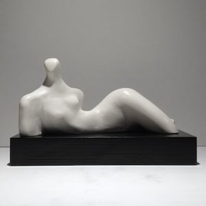 RECLINED FORM SCULPTURE   Solid plaster, hand wax finish, mounted on a black wood plinth, British, modernist art. Limited edition