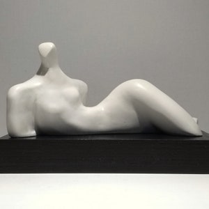 RECLINED FORM SCULPTURE   Solid plaster, hand wax finish, mounted on a black wood plinth, British, modernist art. Limited edition