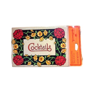 May include: A vintage Hallmark box of cocktail invitations. The front of the box features the word "Cocktails" in a decorative font, surrounded by red and yellow flowers on a black background. An orange label is attached.