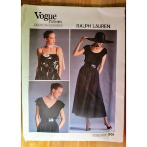 May include: Vogue Patterns American Designer Ralph Lauren sewing pattern for a black dress with a scoop neck and a wide belt. The pattern number is 1909.