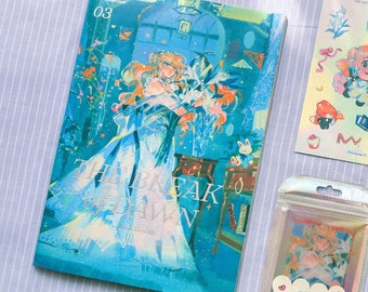 May include: A collection of stationery items featuring illustrations and the text "The Break of Dawn." The items include a notebook, stickers, and clear cards with colorful artwork. A small, clear bag contains additional stickers.