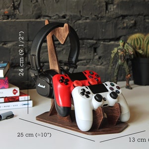 May include: Wooden stand with a headset, two video game controllers, and measurements in inches and centimeters.