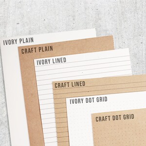May include: Six different paper pads, two in ivory and four in brown craft paper. The ivory pads are labeled "Ivory Plain", "Ivory Lined", and "Ivory Dot Grid". The brown craft pads are labeled "Craft Plain", "Craft Lined", and "Craft Dot Grid".