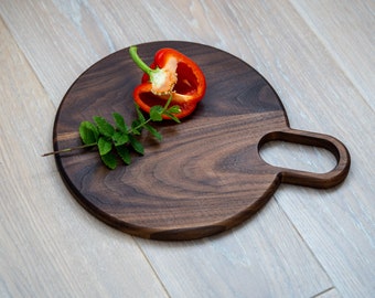 Handmade round walnut serving board with a handle, great home gift