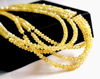 May include: A strand of yellow diamond beads, with a faceted, rough cut. The beads are strung on a wire and are arranged in a loose, flowing pattern.