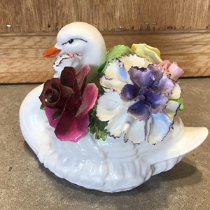 Vintage Porcelain Swan holding China flowers colored pink, yellow and maroon