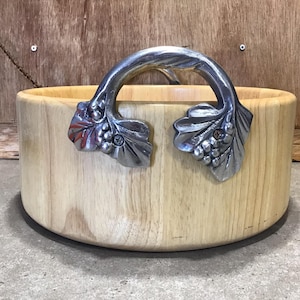 Wood Bowl with Metal handles, this round bowl is an indispensable addition to your serveware collection