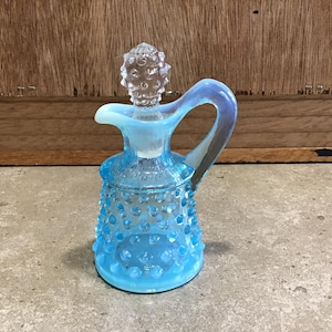 Small Vintage Fenton blue opalescent hobnail glass cruet with stopper.