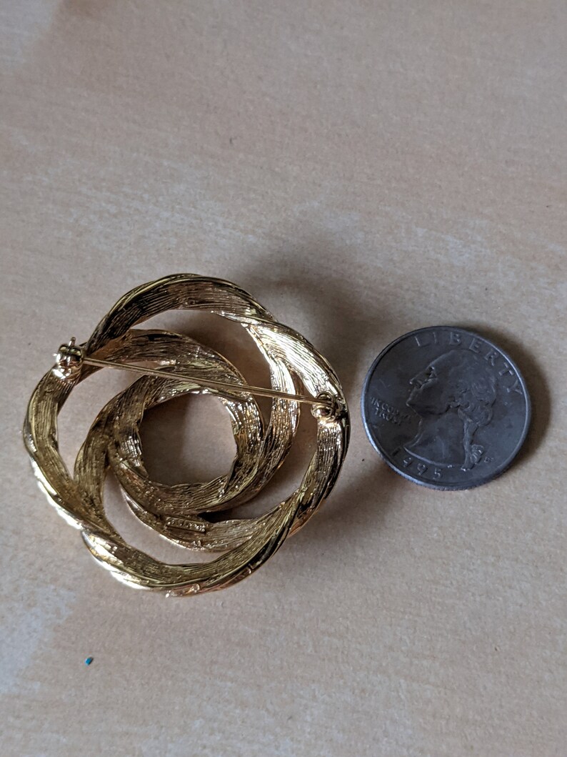 Vintage signed Monet goldtone infinity swirl brooch