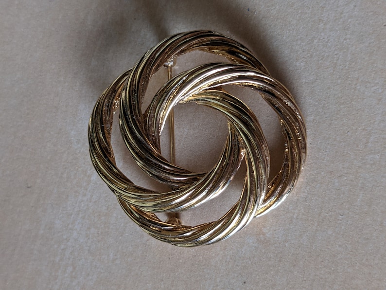Vintage signed Monet goldtone infinity swirl brooch