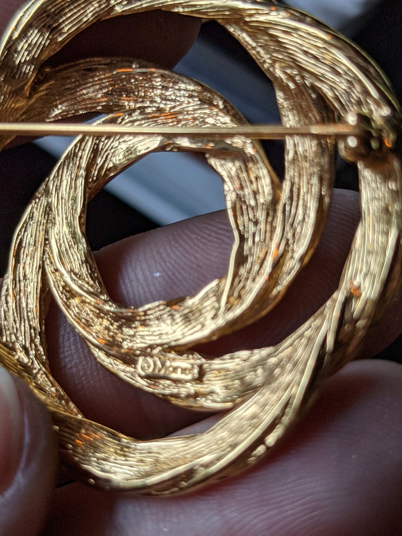 Vintage signed Monet goldtone infinity swirl brooch