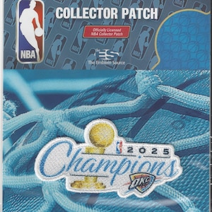 May include: A collector patch in a clear plastic sleeve. The patch features the NBA logo and the words "COLLECTOR PATCH". The patch also has the words "Champions" and "2025 OKC" embroidered on it. The background is a blue net.