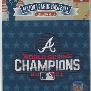 May include: A blue and white embroidered patch with the Atlanta Braves logo and the text "World Series Champions 2021".