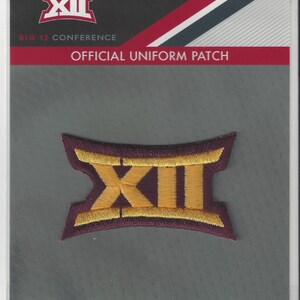 May include: A maroon and gold embroidered patch with the Big 12 Conference logo. The patch is labeled "Official Uniform Patch" and "Big 12 Conference".