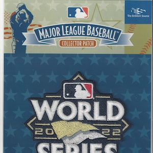 May include: A blue and gold embroidered patch with the words "World Series" and the MLB logo. The patch is surrounded by stars and has the text "Major League Baseball Collector Patch" at the top.
