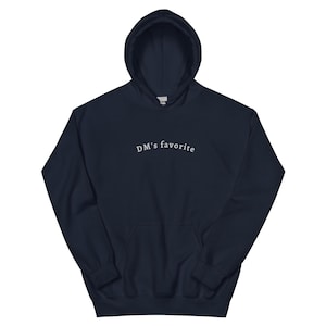 May include: A navy blue hooded sweatshirt with the text "DM's favorite" embroidered in white on the front.