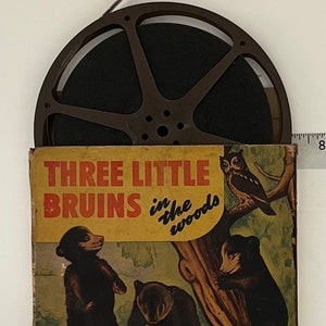 May include: A vintage 16mm film reel in a brown plastic case with a label that reads "Three Little Bruins in the Woods" and "Castle Films Inc."
