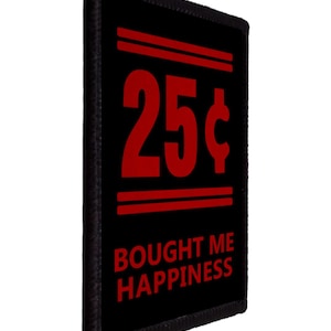 May include: Black rectangular patch with red text and accents. The number "25¢" is centered, above the words "BOUGHT ME HAPPINESS". Two horizontal red lines are above the number. The patch has a black border.