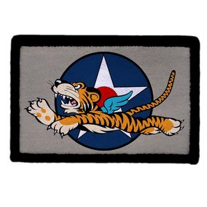 May include: A handmade wooden sign with the text "Welcome" in a whimsical font. The sign is painted white with a distressed finish, and features a decorative floral design in shades of pink and green. It measures approximately 12 inches wide.