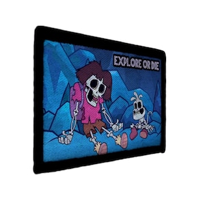 May include: A rectangular patch with a black border. The image shows a cartoon illustration of a skeleton character in a pink shirt and brown shorts, with a skeleton dog. The text "EXPLORE OR DIE" is at the top.