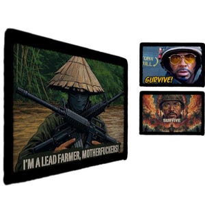 May include: Three rectangular wall art prints with black borders. The largest features a person in a conical hat holding two rifles with the text I'M A LEAD FARMER, MOTHERFUCKERS!. Two smaller prints show a person in a helmet with the text SURVIVE!.