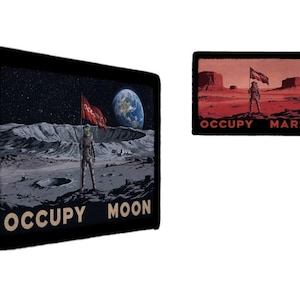 May include: Two black patches with space-themed designs. One shows an astronaut on the moon with the Earth in the background and the text "OCCUPY MOON". The other depicts an astronaut on Mars with the text "OCCUPY MARS".