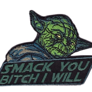 May include: Embroidered patch featuring a green alien character with the text "SMACK YOU BITCH I WILL" in green and white. The alien has large ears and a stern expression. The patch is on a black background.