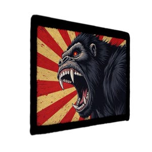 May include: A black rectangular graphic featuring a roaring gorilla with red eyes and sharp teeth. The gorilla is set against a red and yellow sunburst design, framed by a black border. The image has a vintage, retro style.