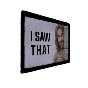 May include: Rectangular patch with a black border and the text "I SAW THAT" in bold black letters. The image features a smiling illustration of Jesus pointing, peeking from behind a stone wall.