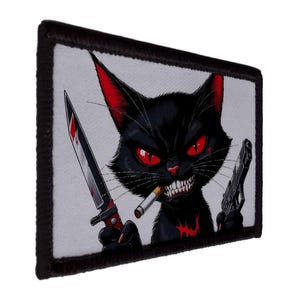 May include: A rectangular patch featuring a menacing black cat with red eyes and ears, holding a knife and a gun, with a cigarette in its mouth. The cat has a menacing grin and a red blood-like marking on its chest.