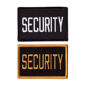 May include: Two rectangular patches with the word "SECURITY" embroidered in white and gold. The top patch is black with white text, and the bottom patch is black with gold text and a gold border.