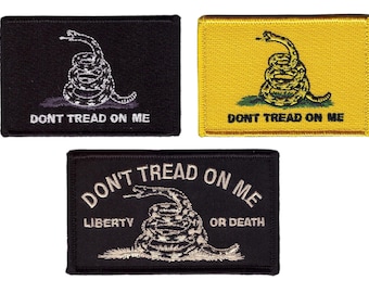 May include: Three rectangular patches with a coiled rattlesnake and the text "DON'T TREAD ON ME". One patch is black with white text and a white snake, another is yellow with a green snake and black text, and the third is black with white text and a white snake, with the text "LIBERTY OR DEATH".