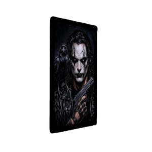 May include: A rectangular wall art print featuring a dark, illustrative portrait of a person with long black hair, white face paint, and black eye makeup. A black raven sits on their shoulder, and they are holding a black handgun.