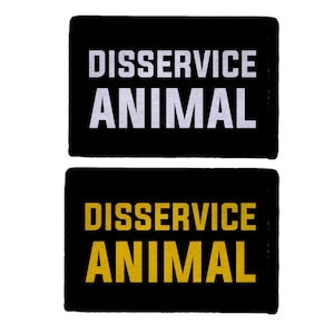 May include: Two black rectangular patches with the words "DISSERVICE ANIMAL" in white and yellow block letters. The patches are likely for a service animal.