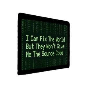 May include: A black framed digital display with green text that reads, "I Can Fix The World But They Won't Give Me The Source Code." The background has a green matrix-style code.