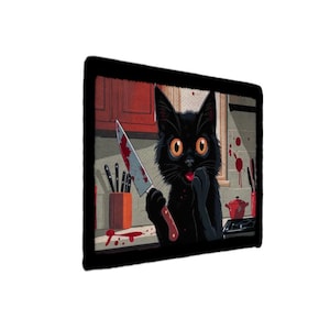 May include: A rectangular wall art print featuring a black cat with large orange eyes standing in a kitchen. The cat holds a knife with red stains on the blade. The kitchen background includes red cabinets, a knife block, and red splatters.