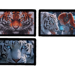 May include: Three rectangular art prints featuring tiger illustrations. One shows an orange tiger face, another a white tiger with a girl, and the last a white tiger face. Each print has a black border.