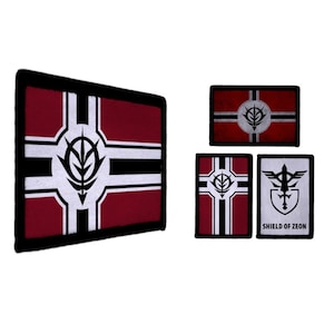 May include: A collection of four embroidered patches. The patches feature a burgundy and white design with a black border. One patch has the text "SHIELD OF ZEON". The patches are rectangular and square.
