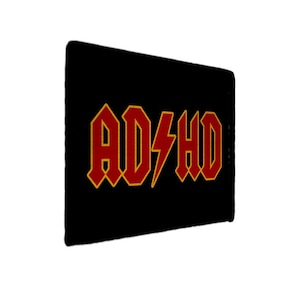 May include: Black rectangle with the text "AD/HD" in red, outlined in gold, with a lightning bolt replacing the slash. The font style is reminiscent of a rock band logo.