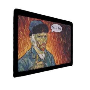 May include: A framed print depicting a parody of Vincent van Gogh, with a bandage on his ear and the text "This is fine" in a speech bubble. The artwork shows the artist in a blue jacket and hat, against a fiery backdrop.