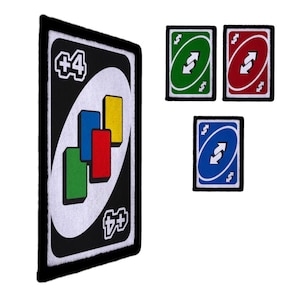 May include: A collection of embroidered patches featuring designs from the card game Uno. The patches include a large black and white +4 card, and smaller green, red, and blue reverse cards. The patches have a black border.