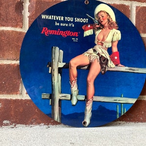 Remington rifles pinup girl metal sign