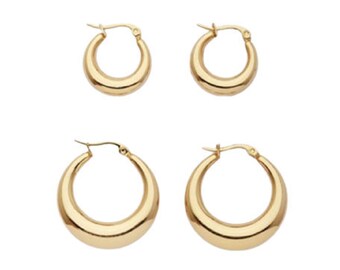 May include: A set of four gold hoop earrings. The earrings are in two sizes, with two smaller hoops and two larger hoops.