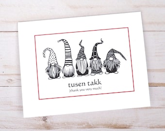 May include: A white card with a red border featuring five black and white gnomes with different hats. The card says "tusen takk" (thank you very much).