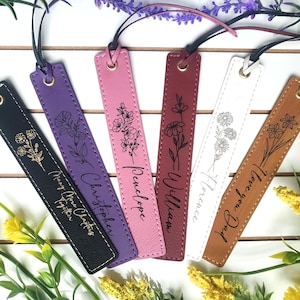 May include: Six rectangular bookmarks in black, purple, pink, maroon, white, and tan leather. Each features a black cord, a metal eyelet, and a unique floral line art illustration with custom text including names and phrases like I love you Dad.